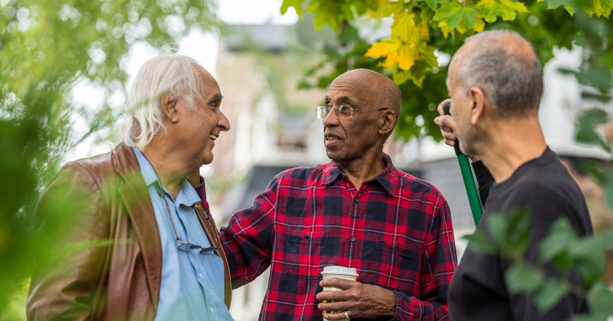 Group of older men talking.